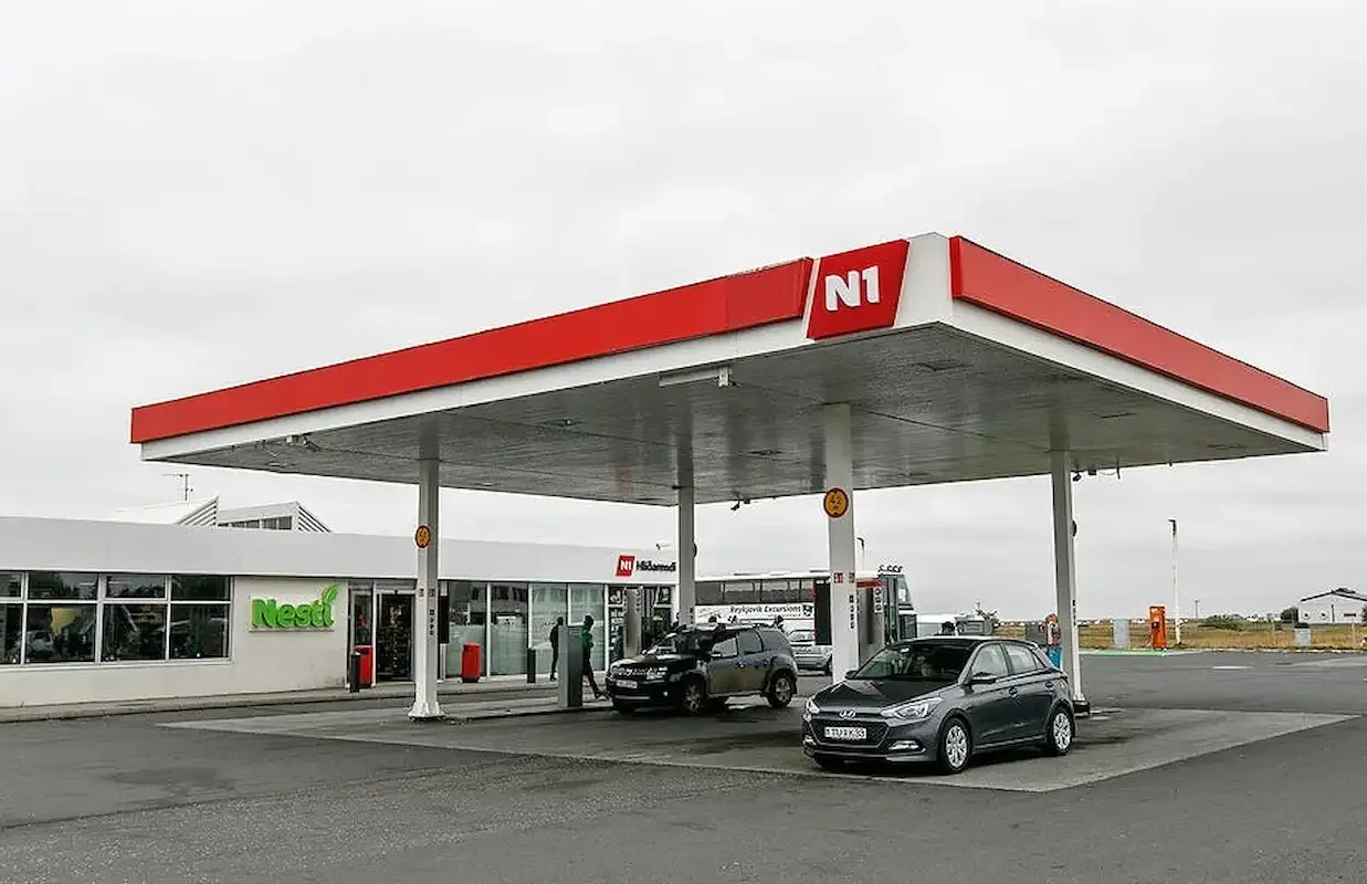 Self service fuel station in Iceland showing fuel prices that affect road trip costs when converted to USD