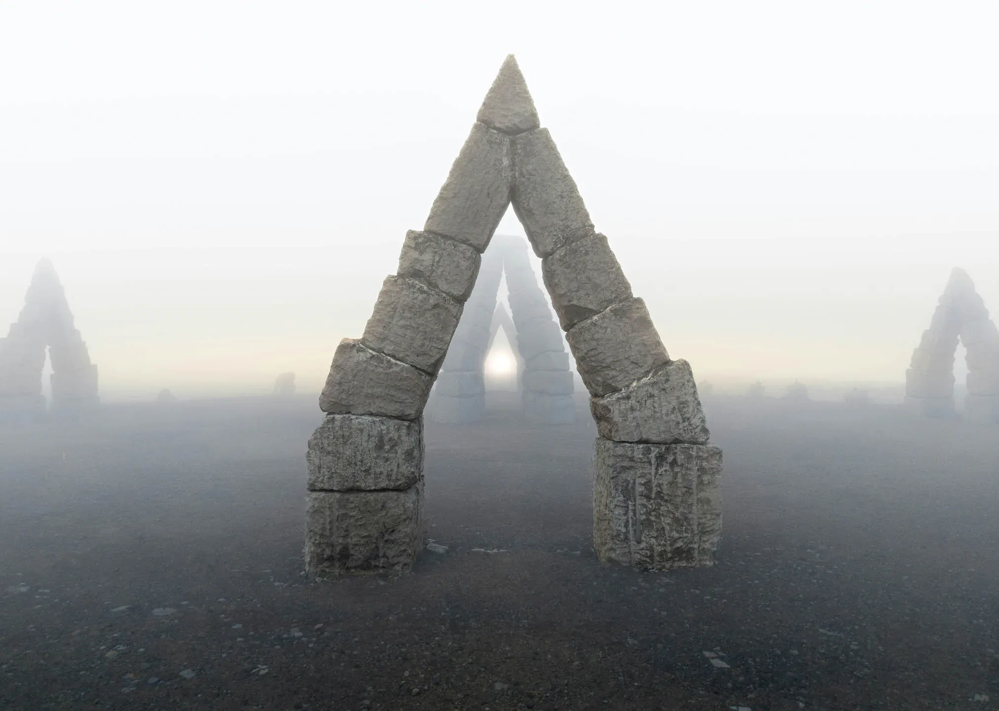 Fog covered Arctic Henge Iceland stone arch rising from a barren volcanic landscape with multiple stone triangles fading into the mist.