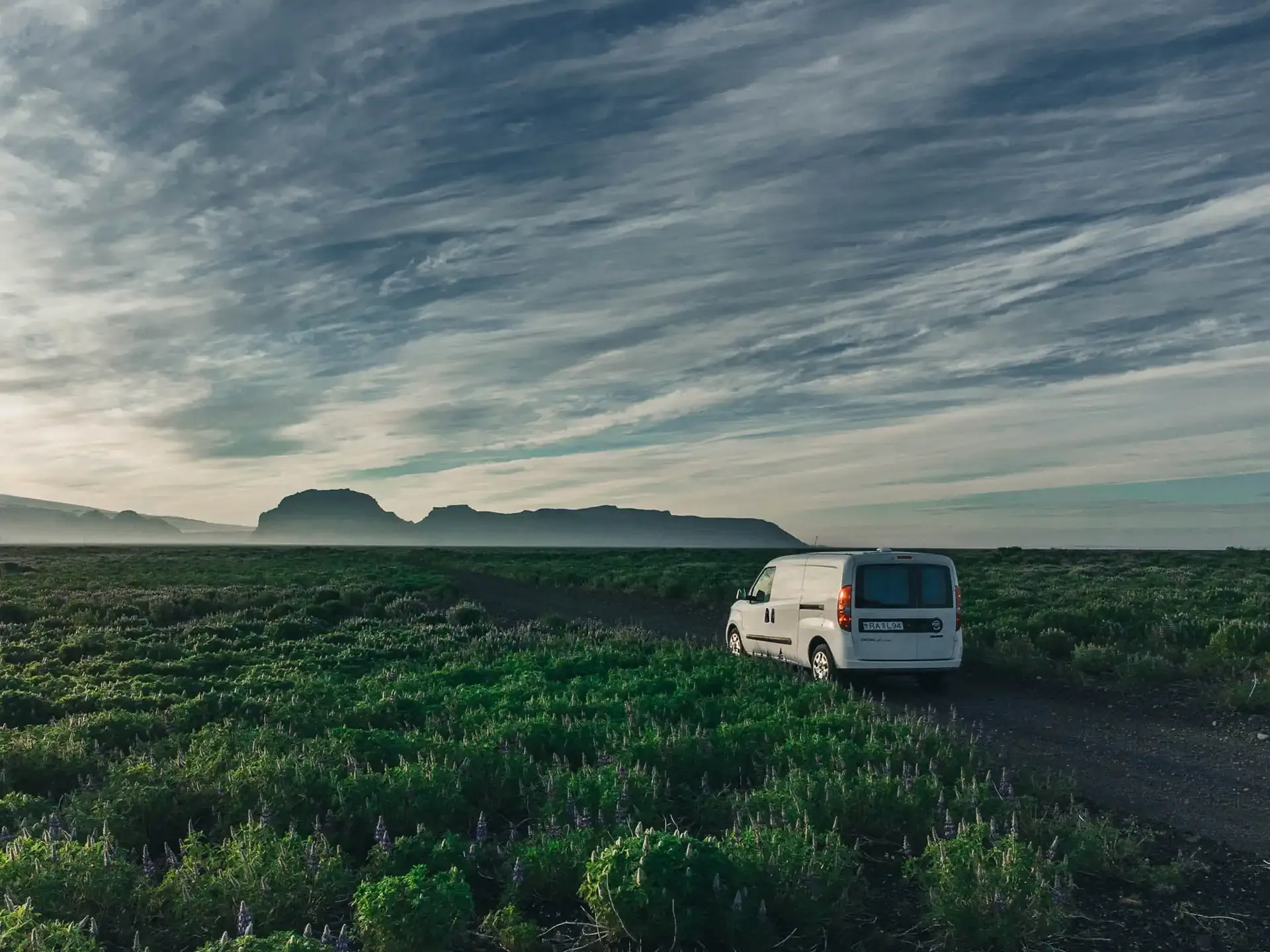 Campervan driving on an Icelandic gravel road showing real road conditions travelers face