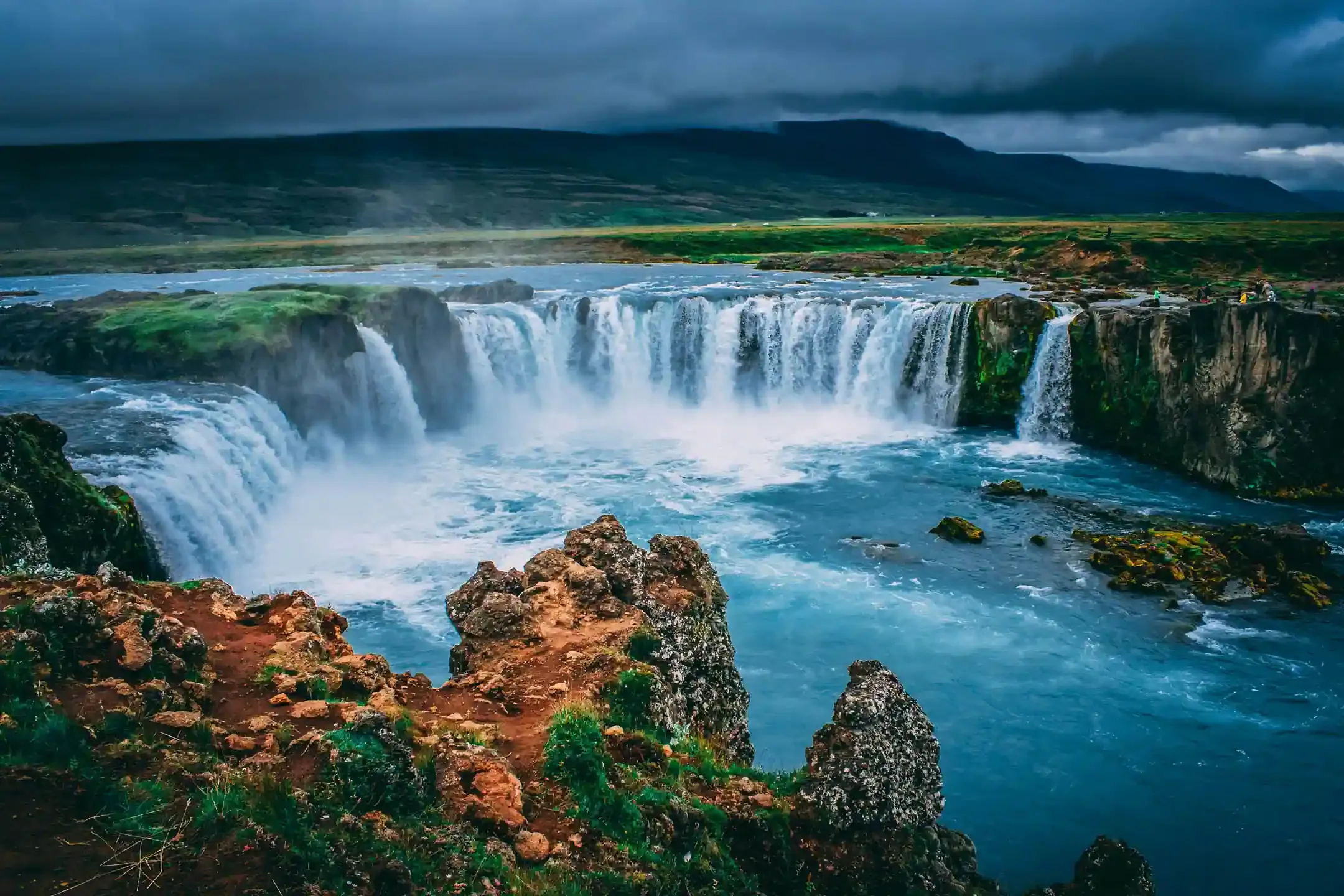 North Iceland road trip stop at Goðafoss waterfall with turquoise water and basalt cliffs