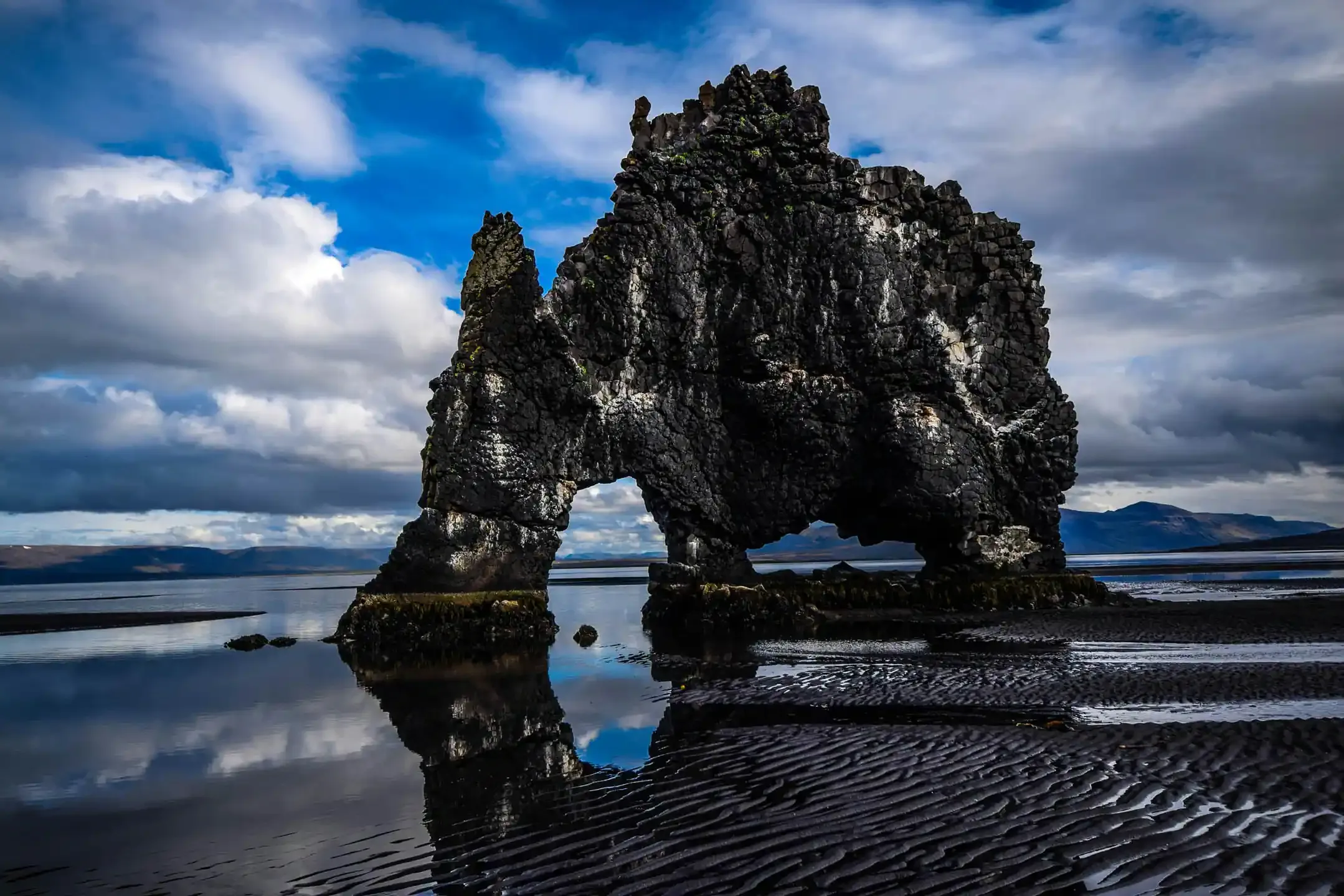 Remote coastal landscape with mountains, sea cliffs, and dramatic northern scenery