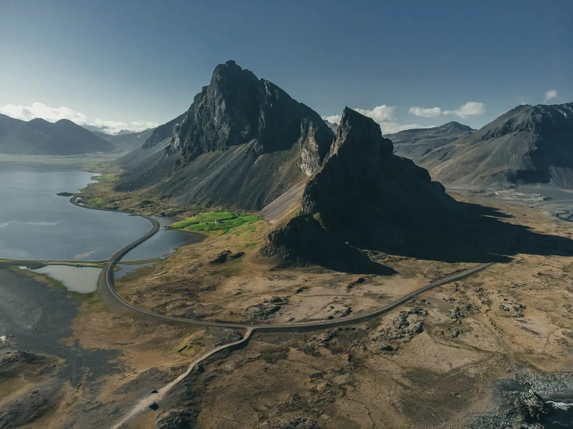 4x4 campervan Iceland driving near rugged mountains on paved coastal road