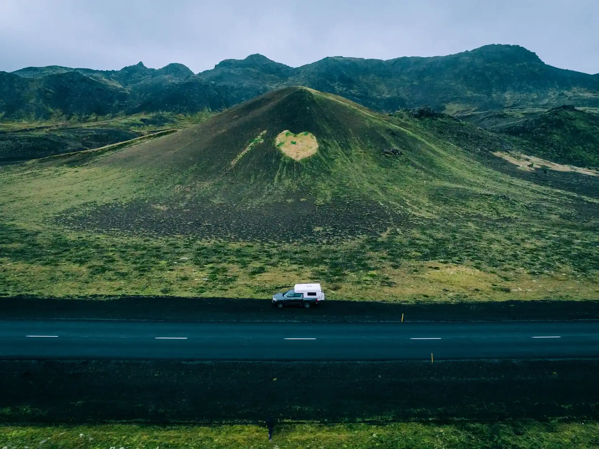 4x4 campervan driving past a volcanic hill in the Icelandic highlands