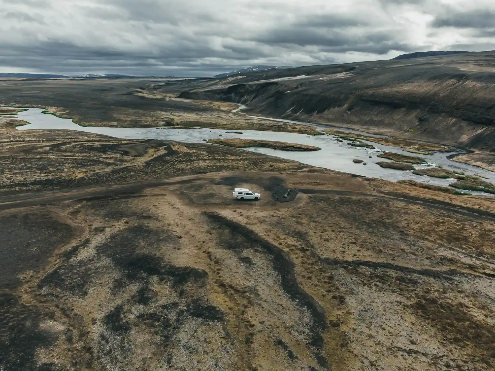 4x4 campervan Iceland parked in volcanic highlands overlooking river canyon