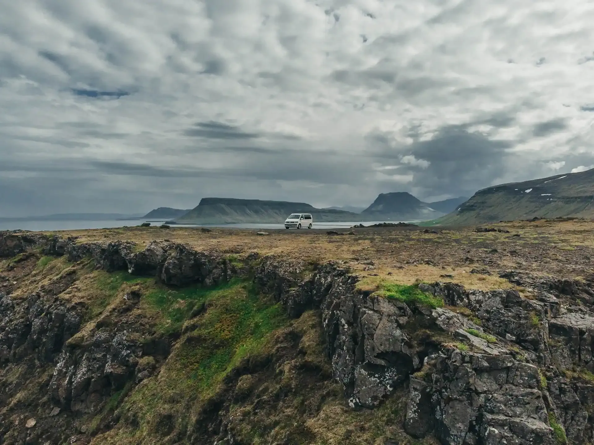 Campervan rental Iceland VW California parked on an Icelandic cliff