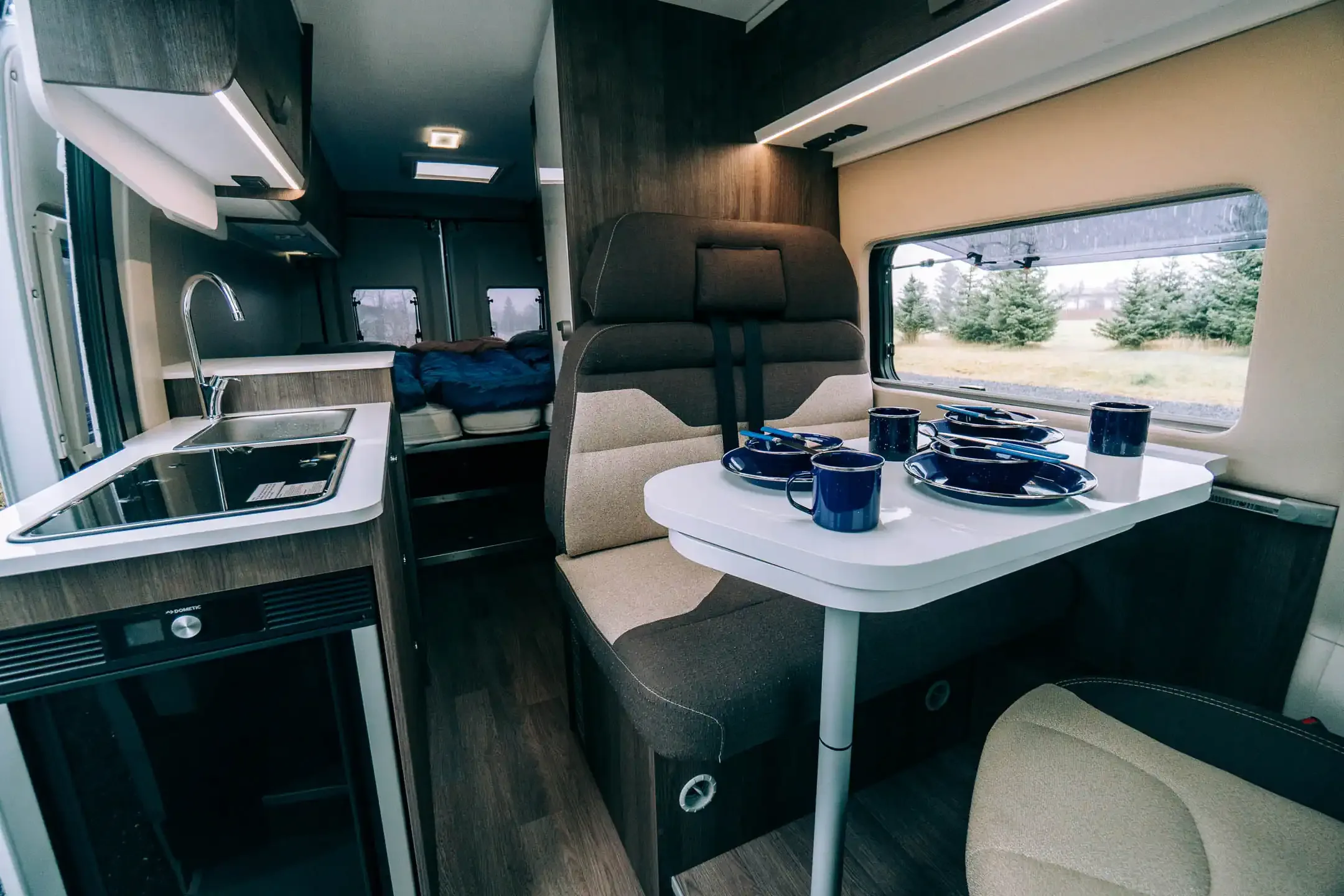 Campervan interior in Iceland showing sleeping area, kitchen and storage for road trip comfort