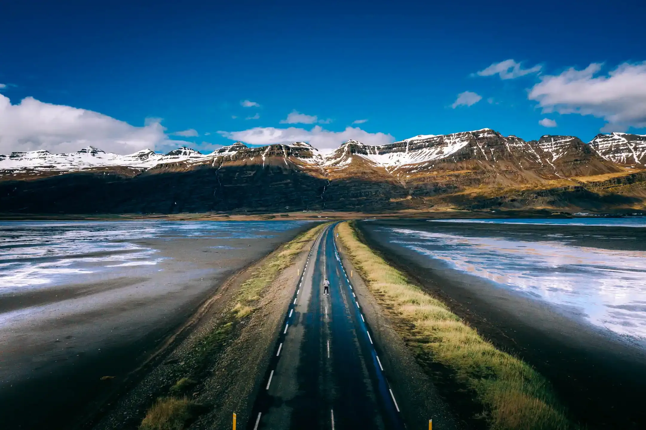 campervan travel Iceland driving through coastal plains and mountain scenery