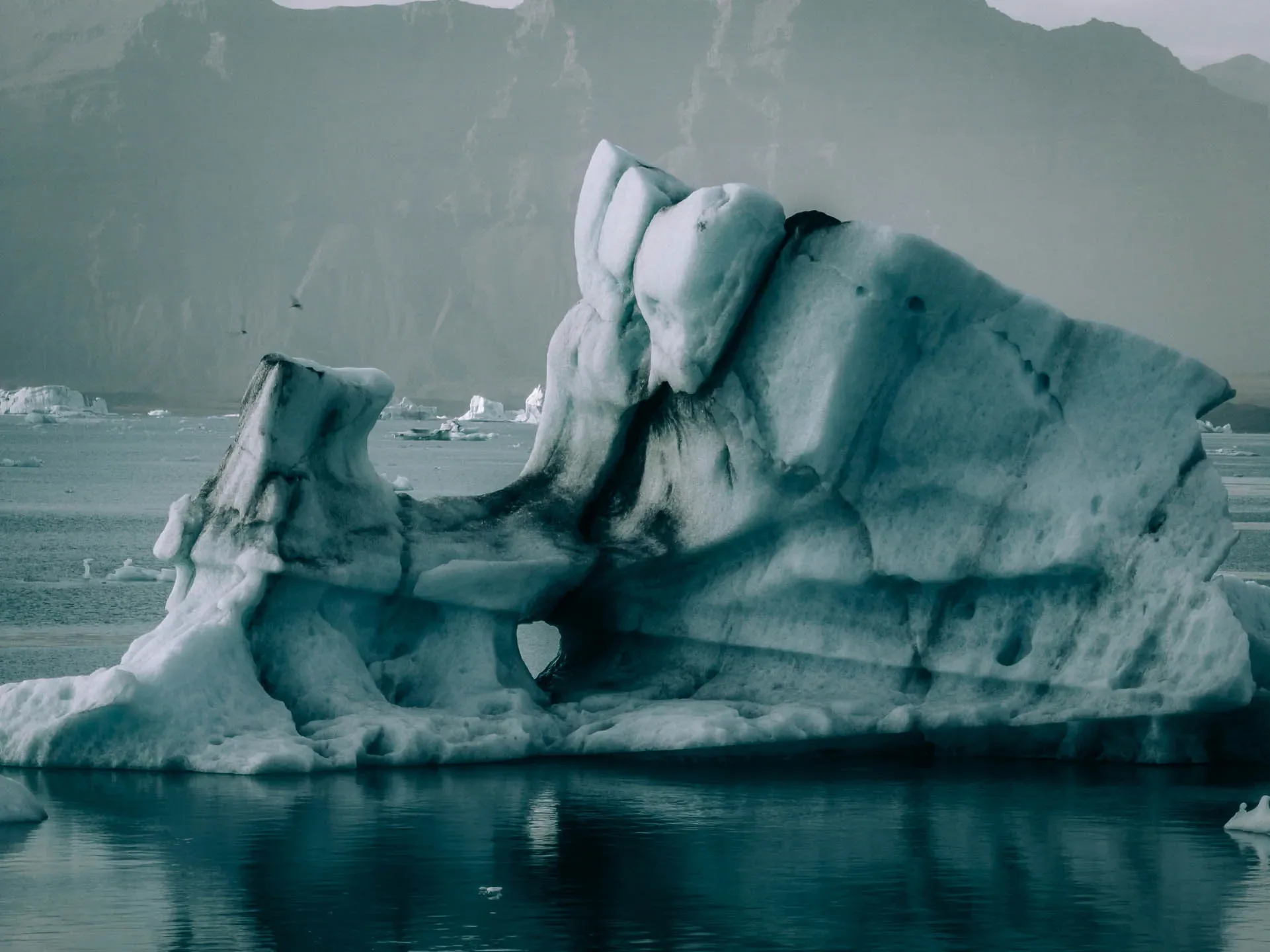 Large blue iceberg floating in a glacial lagoon in Vatnajökull National Park, Iceland 