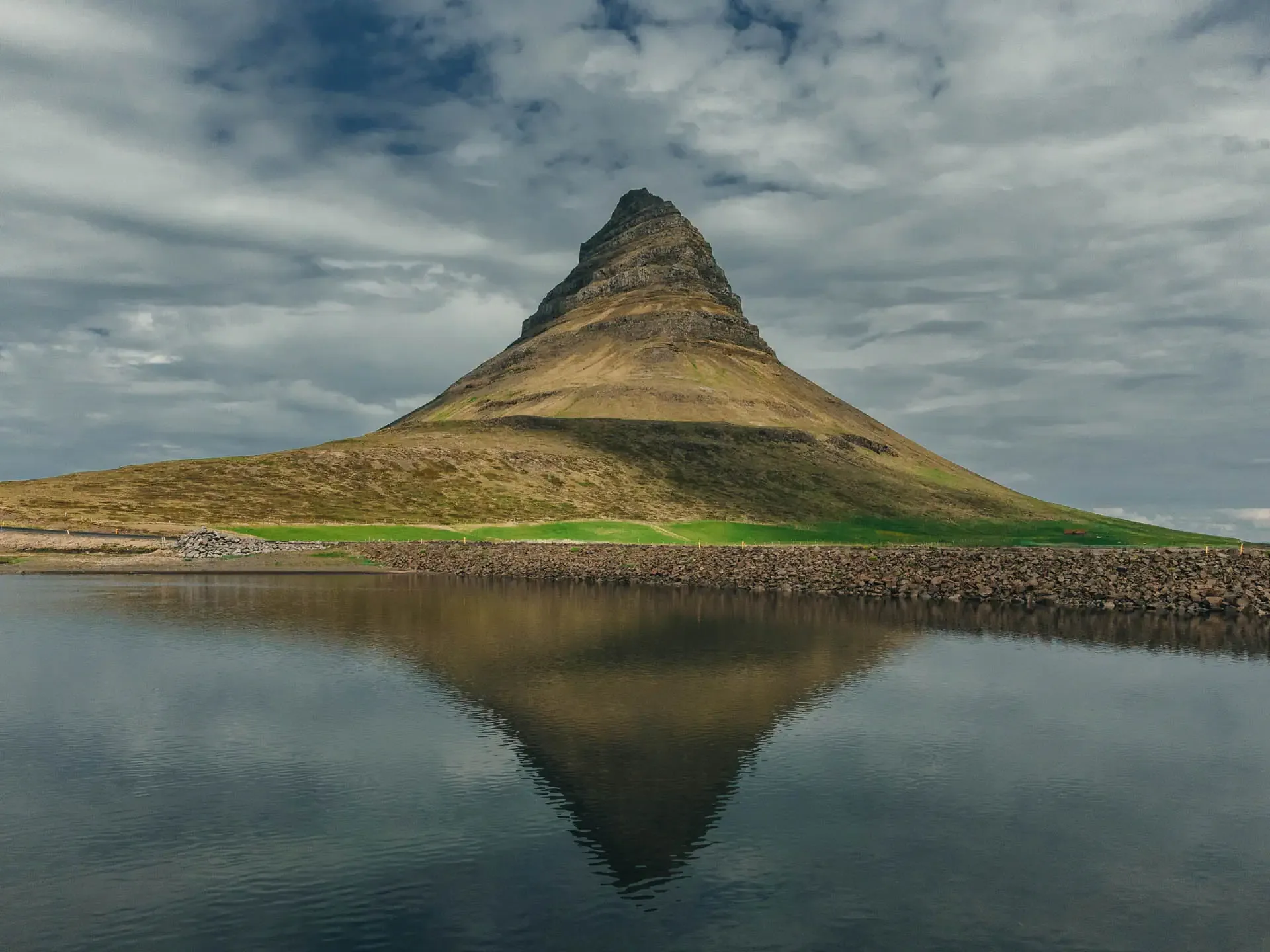 Kirkjufell mountain reflecting in still water on the Snæfellsnes Peninsula during an Iceland Ring Road campervan itinerary