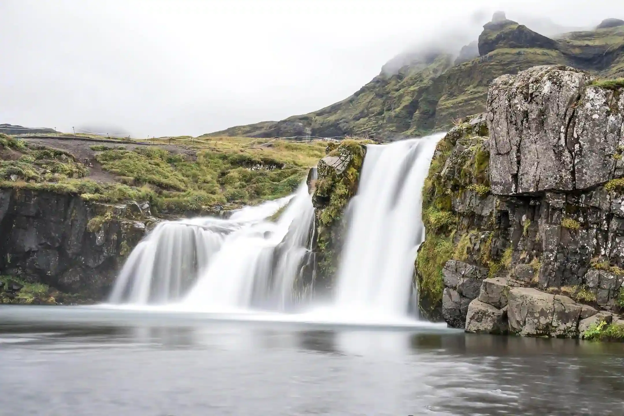 Icelandic waterfall flowing into a clear river that feeds local drinking water supplies