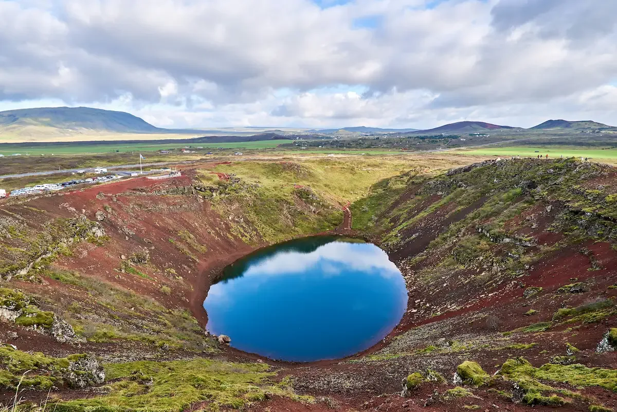 Kerið volcanic crater lake with red slopes and blue water on the Golden Circle route in Iceland